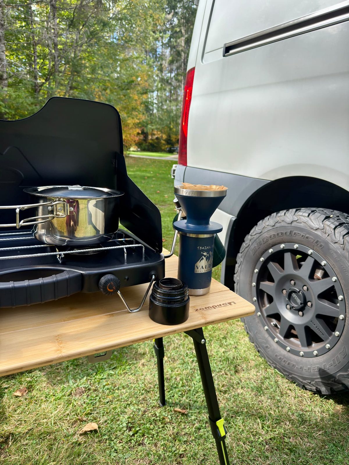 Pour-over coffee and camp kitchen beside the Sprinter
